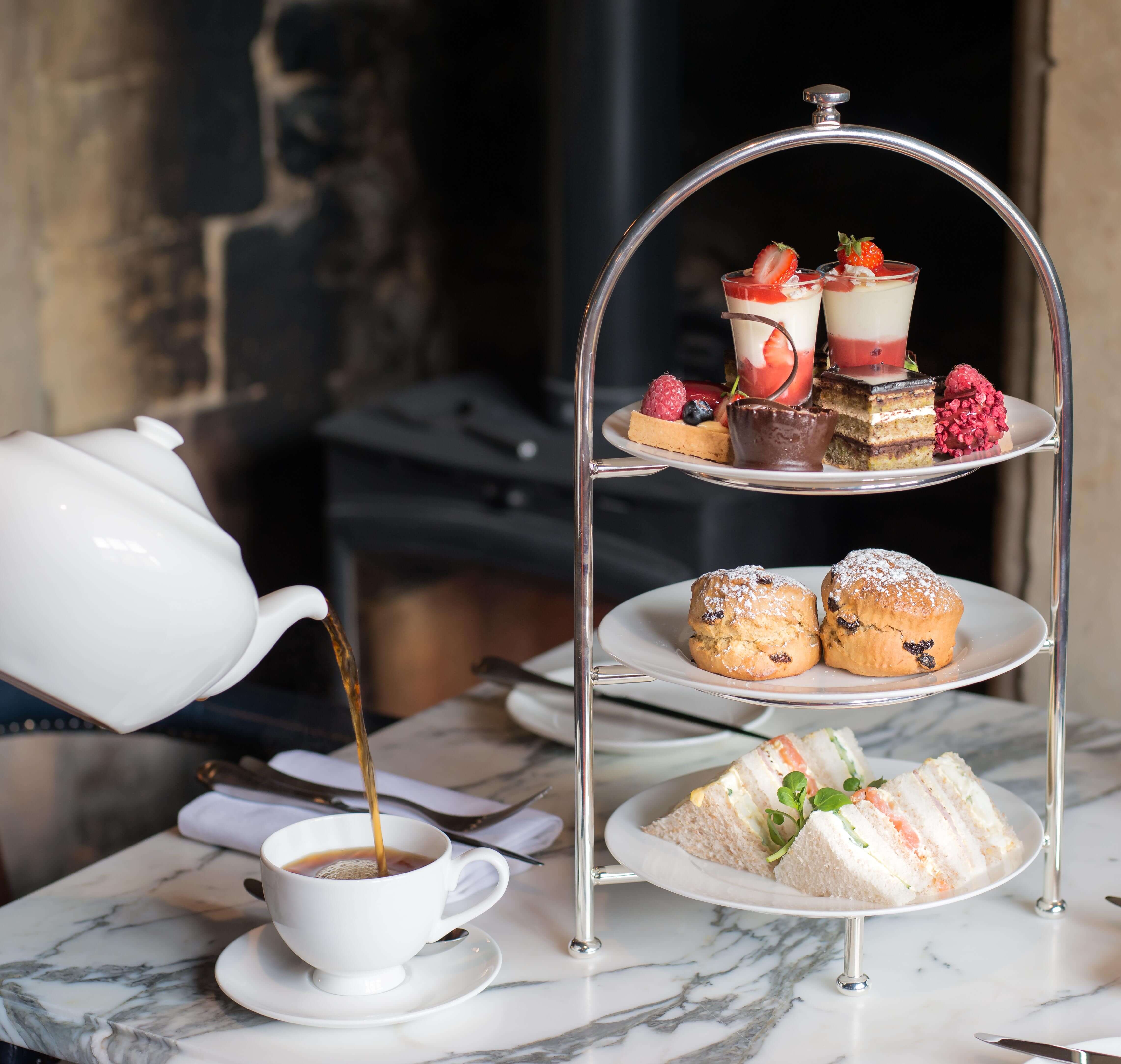 Three-tiered afternoon tea at The Lygon Arms, with seasonal finger sandwiches, scones and sweet options; served with a variety of teas.