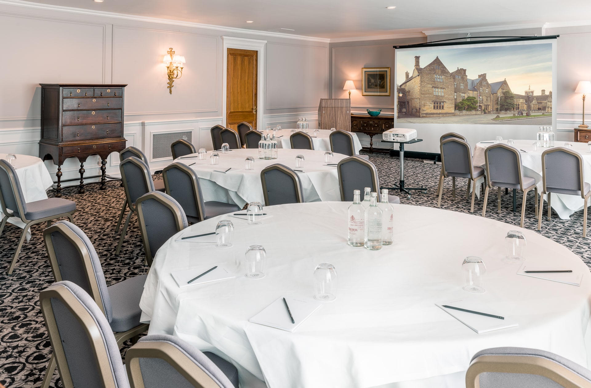 Elegant dining room with cabaret table set for a formal meal.