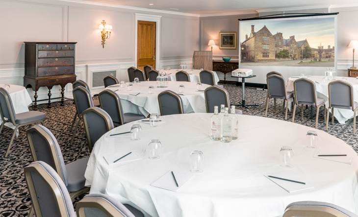 Elegant dining room with cabaret table set for a formal meal.