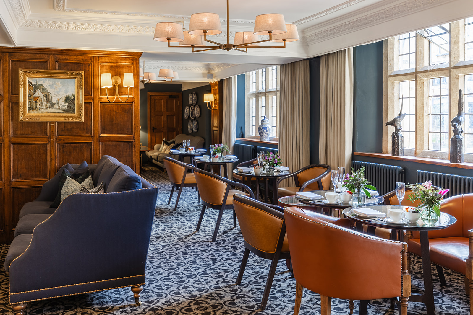 Elegant lounge with sofas, wood paneling, and modern décor.