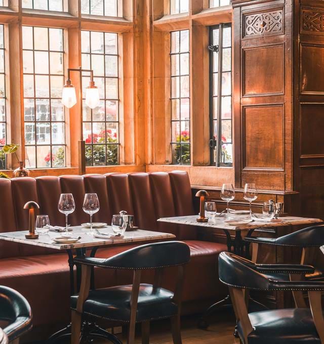Restaurant seating area, with large windows and modern decor