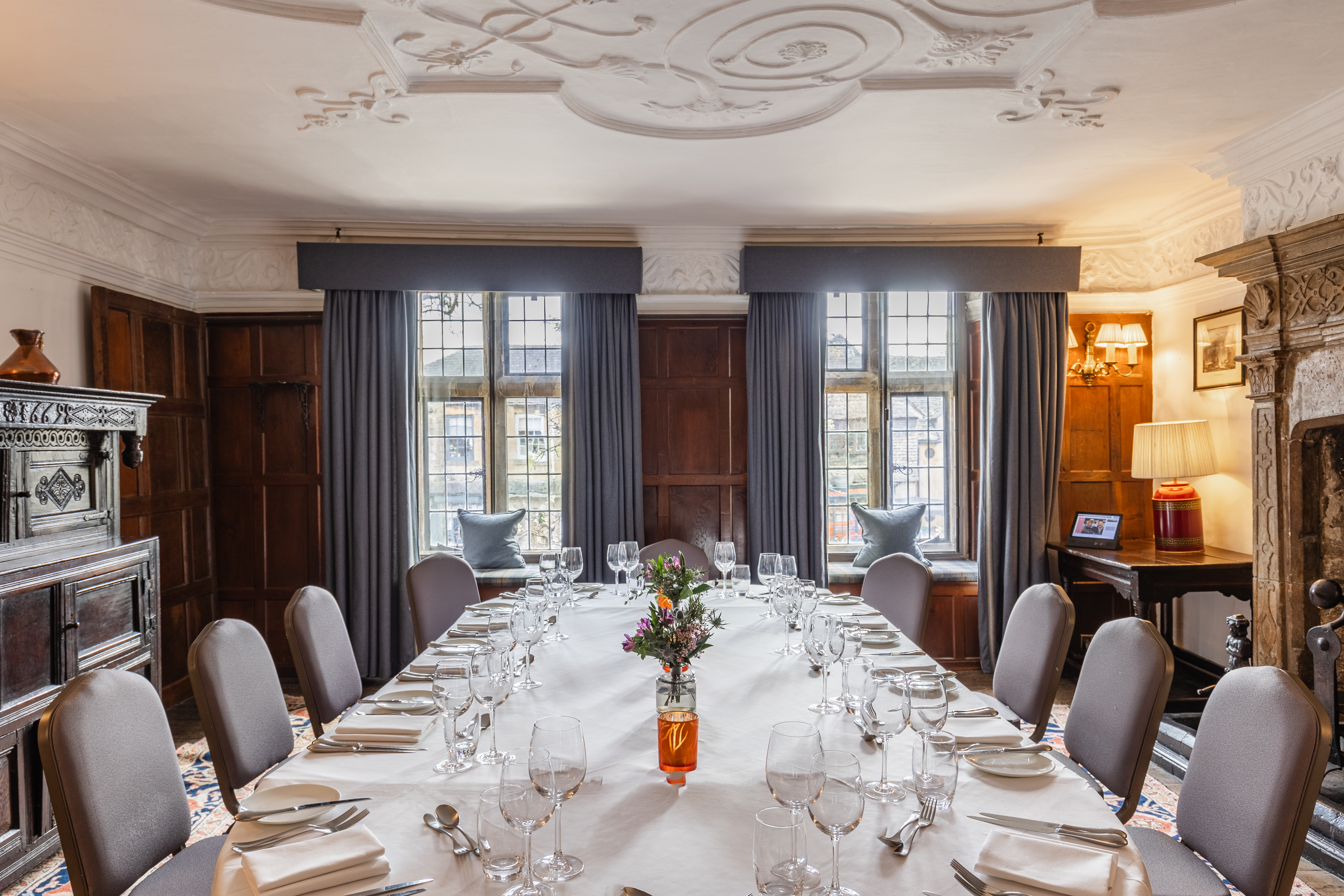 Elegant dining room with long table set for a formal meal.