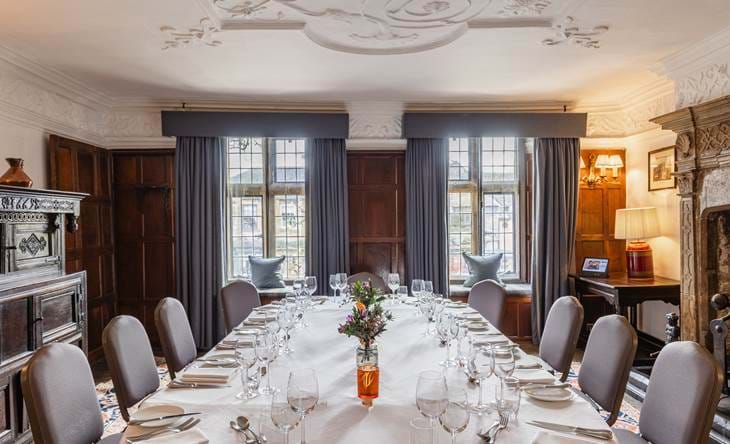 Elegant dining room with long table set for a formal meal.