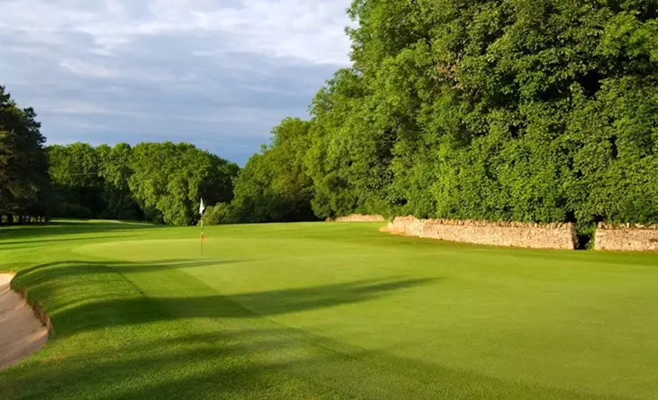 Sunny golf course with green fairway